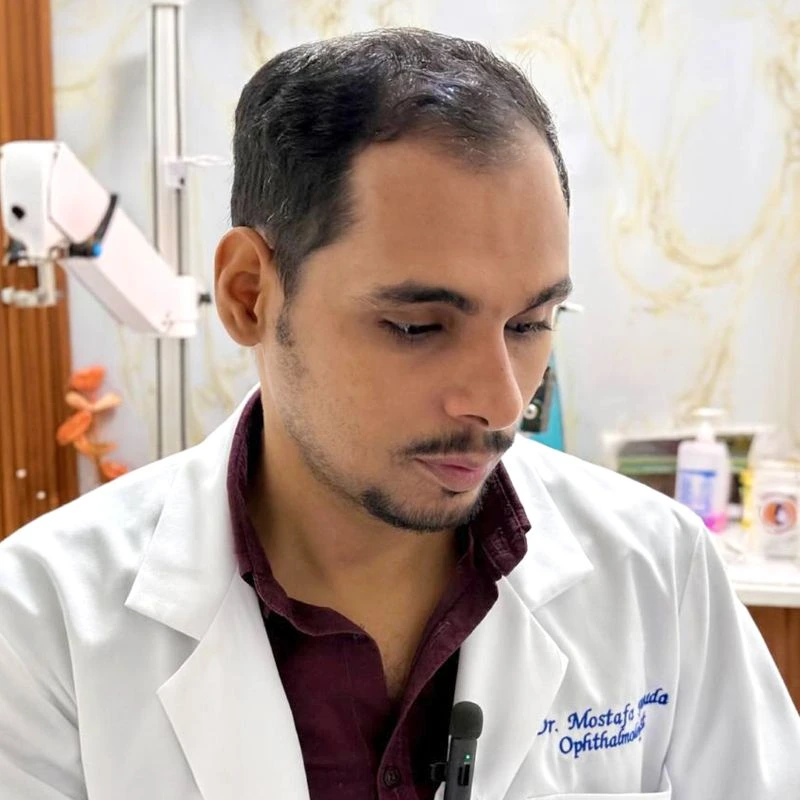 Dr. Mostafa Abouda, an experienced Ophthalmic Surgeon, conducting a detailed eye examination for a male patient with a slit lamp.